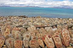 
A row of mani rocks shine in one of the brief sunny breaks next to Seralung Gompa on the shores of Lake Manasarovar.
